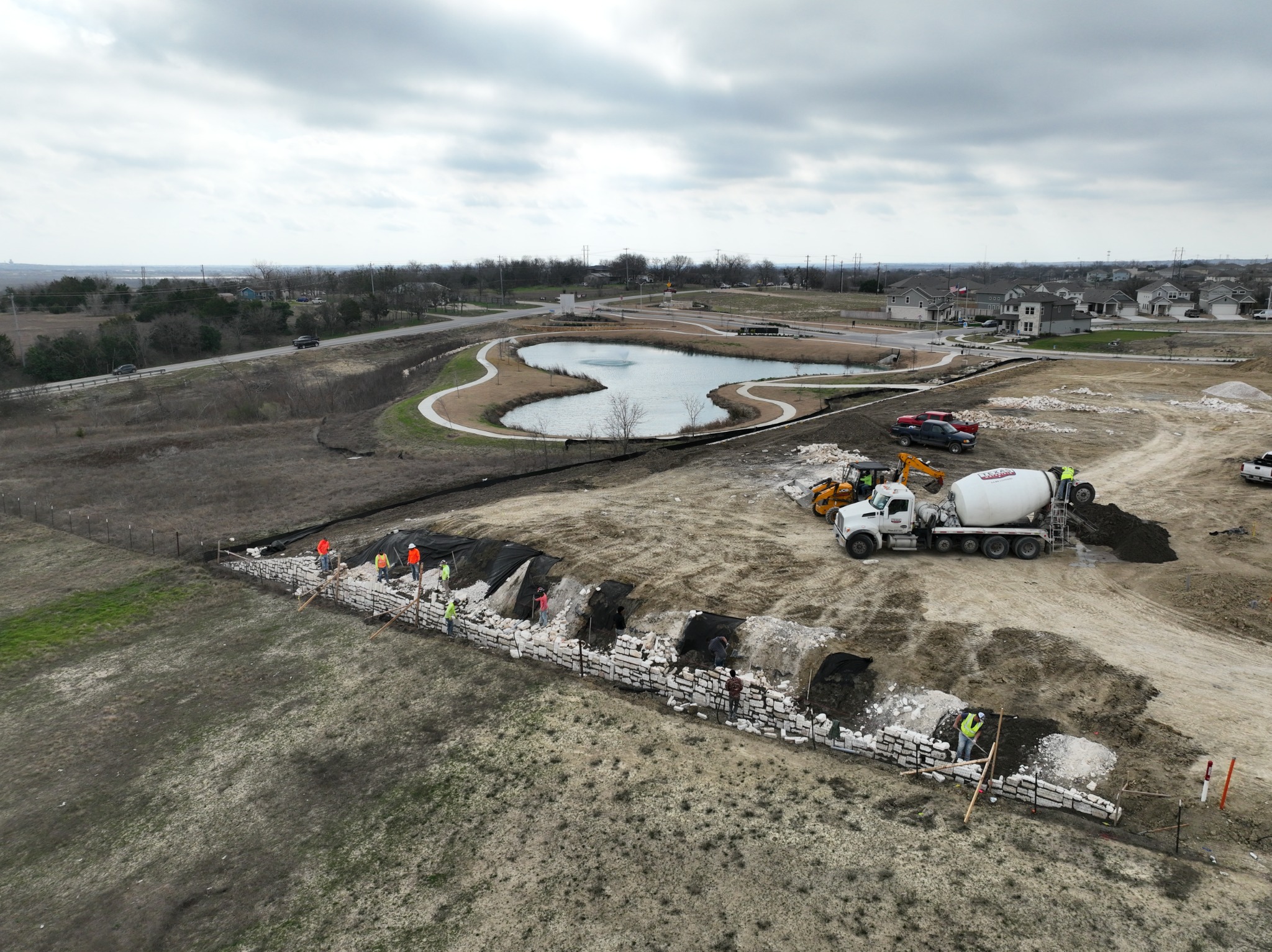 Aerial view of natural stone gravity retaining wall construction at Porter Country in Austin, Texas