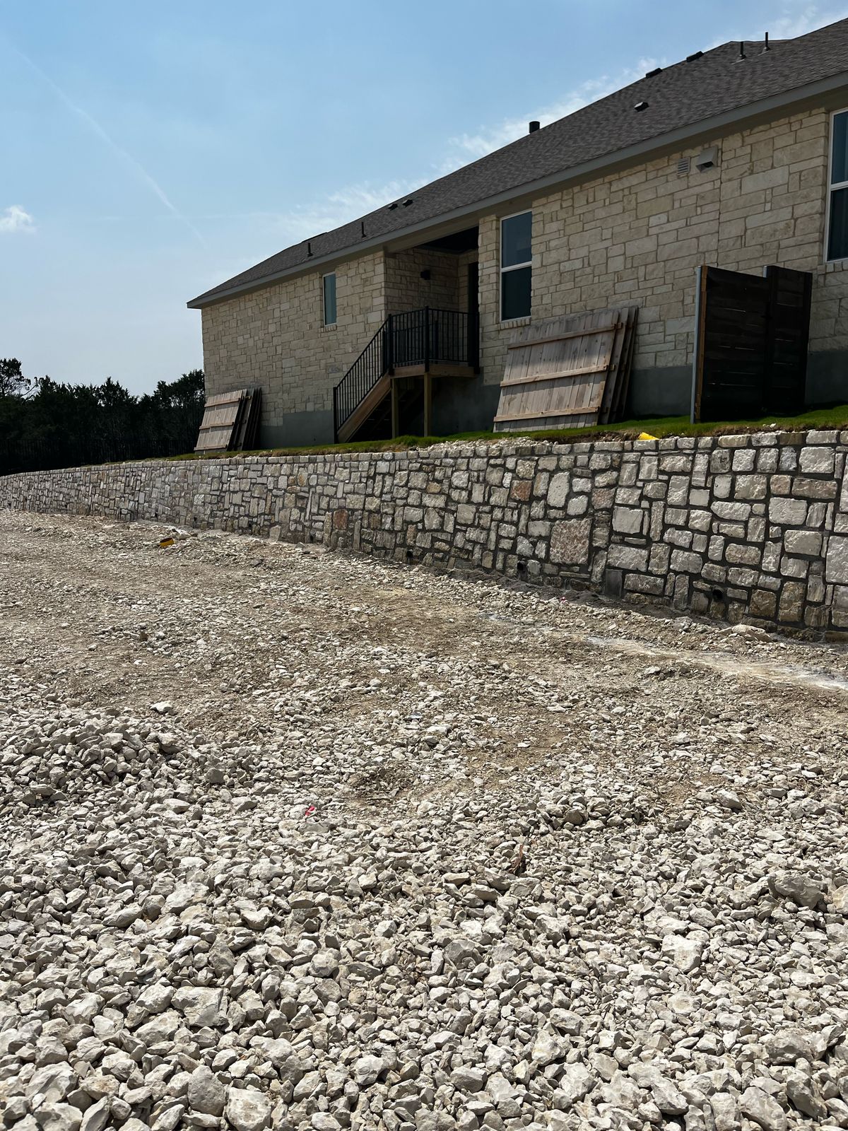 Natural stone gravity wall near residential buildings